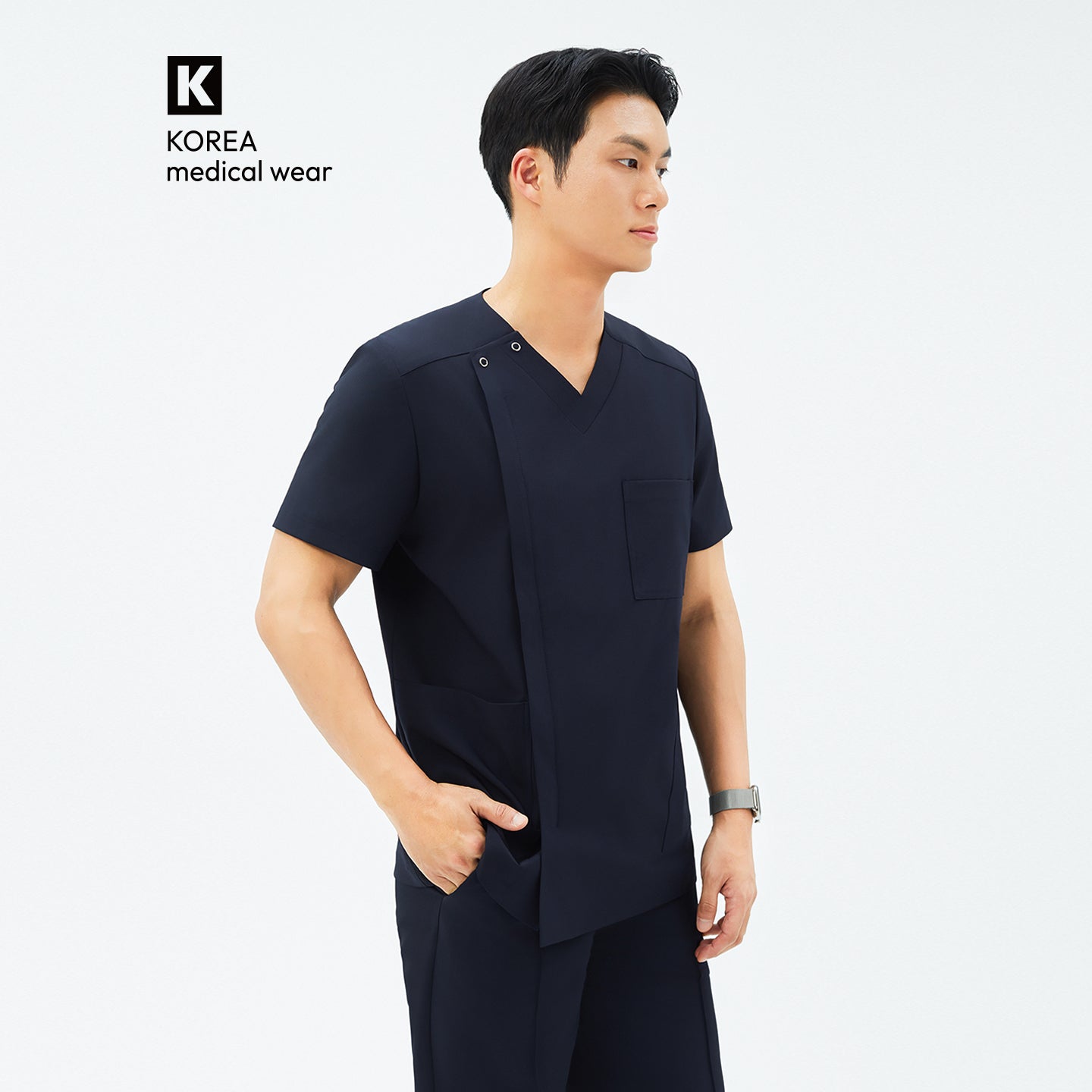 Image of Side angle of TUL DS-185 Men's V-Snap Zipper Scrub Top in Eco Navy, featuring a V-neck with snap details and a spacious front pocket.